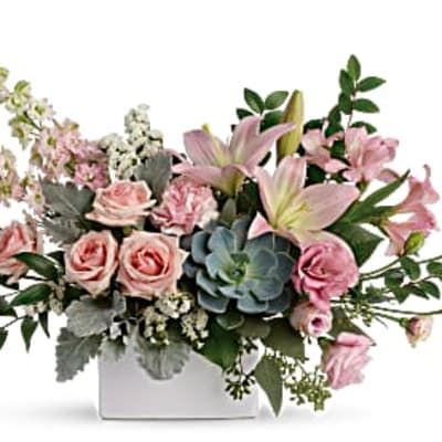 Low pink rose and lily arrangement with a succulent in a white rectangular vase