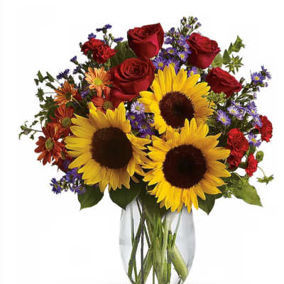 Bouquet of sunflowers, red roses, and purple daisies in a clear glass vase