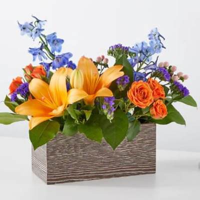 Orange lilies and roses in a rectangular wooden box