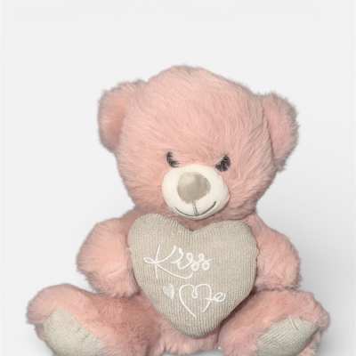 Pink teddy bear holding a heart with "Kiss Me" text