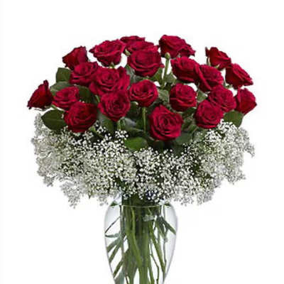 Red roses in a clear glass vase with white baby's breath