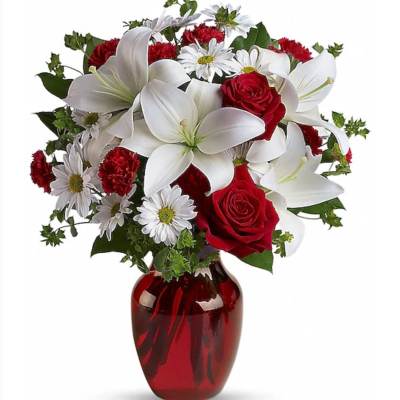 Red roses and white lilies in a red glass vase
