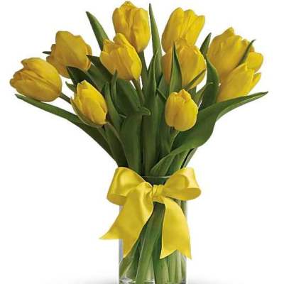 Yellow tulips in a clear glass vase tied with a yellow ribbon