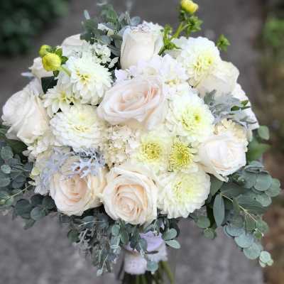 Bouquet of white roses and pale blooms with eucalyptus