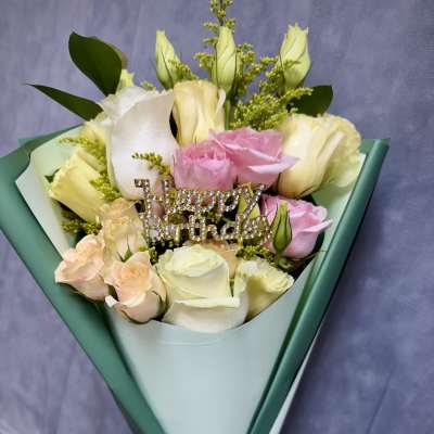 Bouquet of pink and white roses with a rhinestone "Happy Birthday" pick