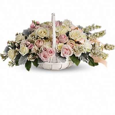 Pastel rose arrangement in a white basket with a handle