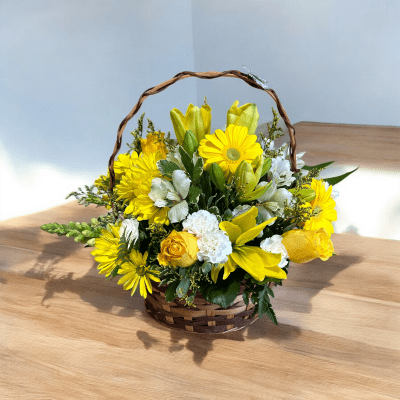 Yellow flowers in a wicker basket with a curved handle