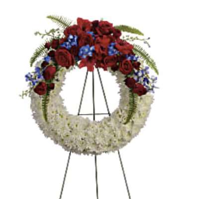 Standing funeral wreath with red and white flowers on an easel