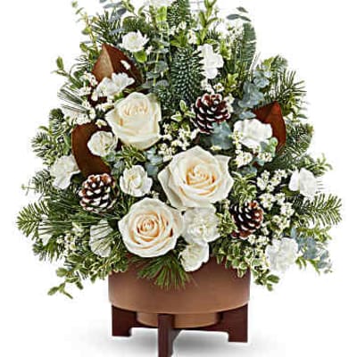 White roses and pinecones in a brown container