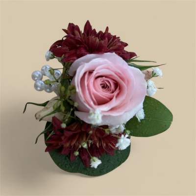 Pink rose with burgundy chrysanthemums and small white filler flowers