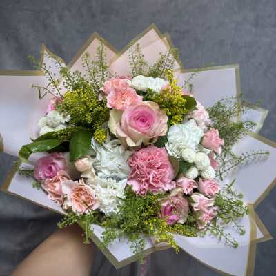 Pink and white mixed bouquet wrapped in paper