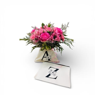 Pink rose bouquet in a cream tote bag with a matching pouch