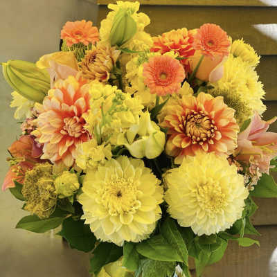 Yellow and orange mixed bouquet in a glass vase