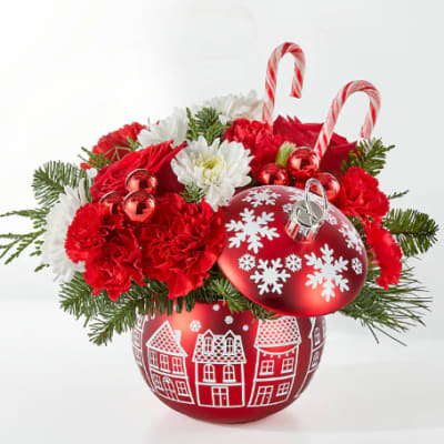 Christmas arrangement in a red ornament vase with candy canes and snowflake decorations