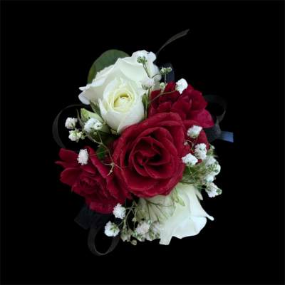 Red and white rose bouquet with baby's breath on a black background