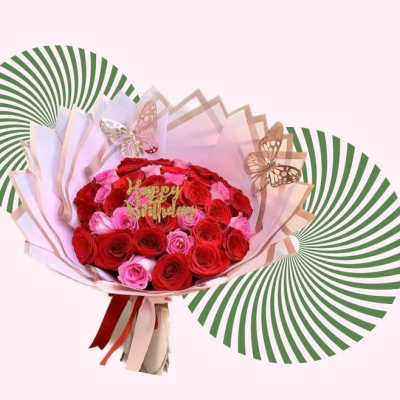Bouquet of red and pink roses with butterfly decorations
