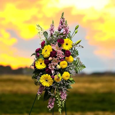 Tall floral spray with yellow daisies, pink lilies, and purple blooms