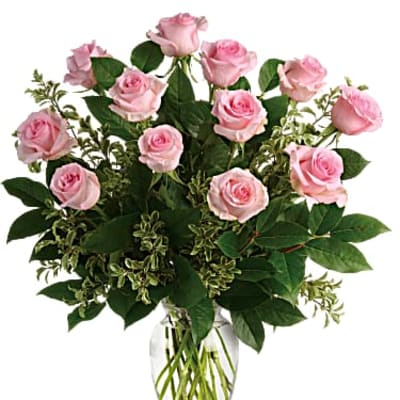Arrangement of light pink roses in a clear glass vase