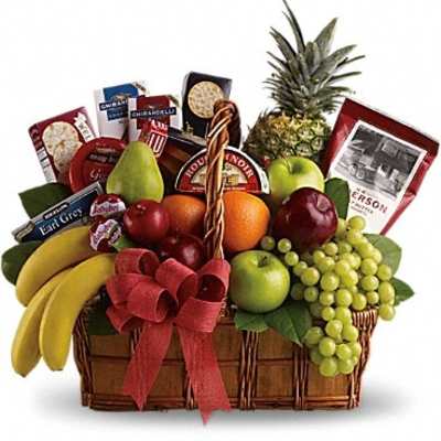 Fruit basket with bananas, grapes, apples, pineapple, and packaged snacks