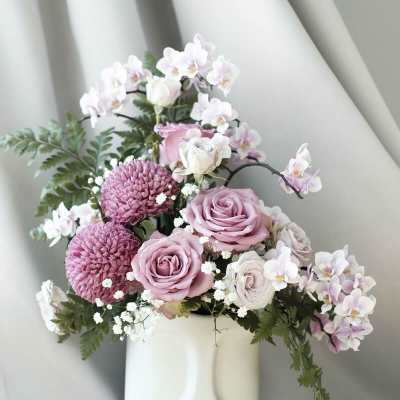Pink and white floral arrangement in a white vase