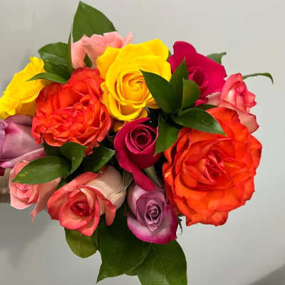 Bouquet of multicolored roses with green leaves