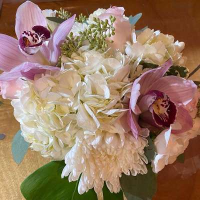 Bouquet of white hydrangeas, pink orchids, and white chrysanthemums