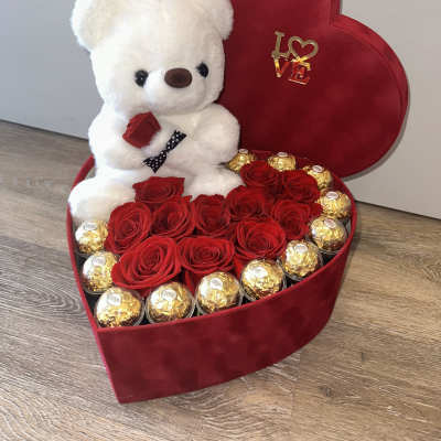 Beautiful velvet box with a teddy bear, Ferrero Rocher chocolates encased in acrylic, and red roses.