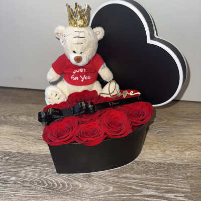 Small heart-shaped box (DIOR) with teddy bear wearing a metal crown, red roses, ribbon and door bow