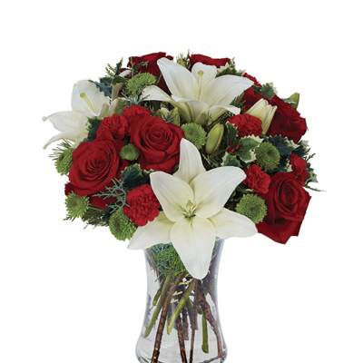 Red roses and white lilies arranged in a clear glass vase
