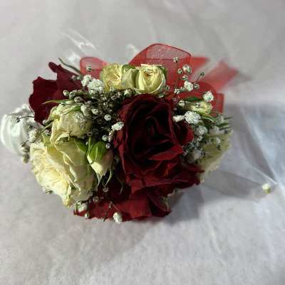 Bouquet of red and cream roses wrapped in clear plastic