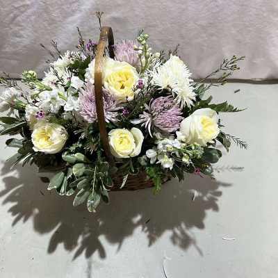 Basket of white and pale yellow flowers with lavender blooms