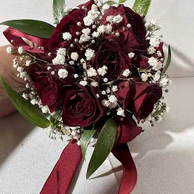 Bouquet of deep red roses with white baby's breath and ribbon