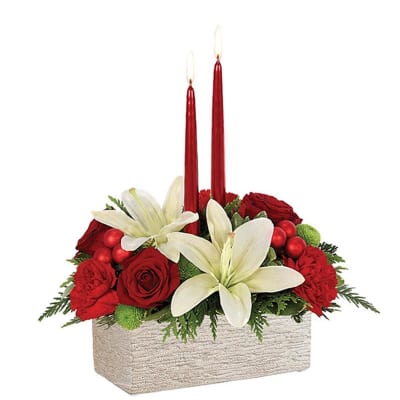 Red roses and white lilies in a rectangular container with two red candles