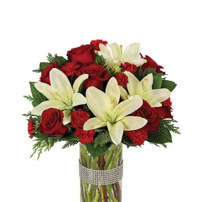 Red roses and white lilies arranged in a glass vase