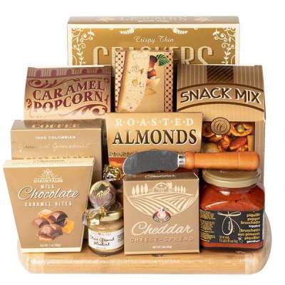Gift basket with snack boxes, chocolates, nuts, and a cheese spread