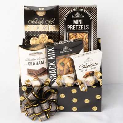 Gift basket with assorted snack boxes and chocolates in a black polka-dot container