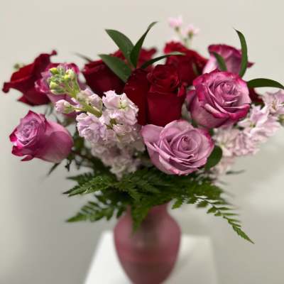 Bouquet of red and pink roses in a pink vase