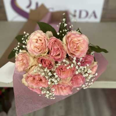 Bouquet of pink roses with baby's breath wrapped in pink paper