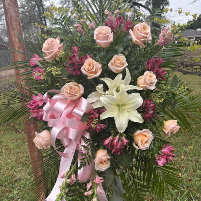 Pink rose and white lily standing spray with a pink ribbon