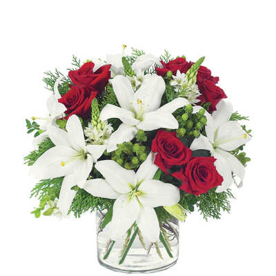 Red roses and white lilies in a clear glass vase
