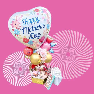Mother's Day balloon bouquet with gift items on a pink background
