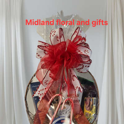 Gift basket with assorted snacks and candy, topped with a red ribbon bow
