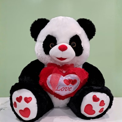 Plush panda bear holding a red heart with "Love" text