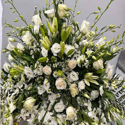 Large white floral spray with roses and lilies