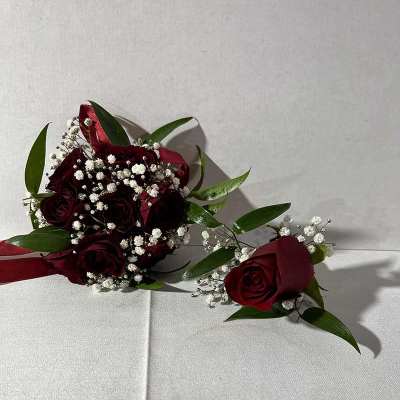 Red rose bouquet with baby's breath and a matching boutonniere