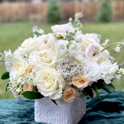 White and blush bouquet in a white vase