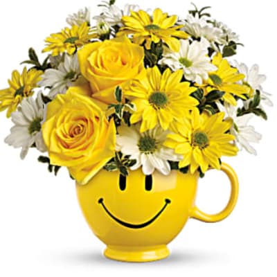 Yellow roses and daisies in a yellow smiley-face mug