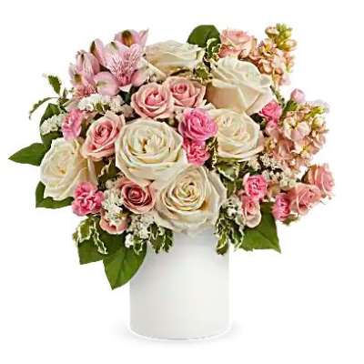 Pink and white rose bouquet in a white cylindrical vase