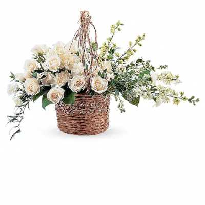 Cream roses arranged in a wicker basket with trailing greenery