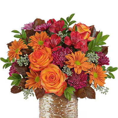 Bouquet of orange and red flowers in a woven basket vase